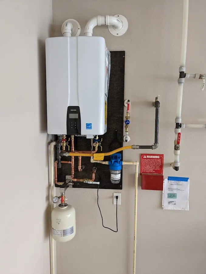 Professional plumber installing copper piping in a Harrison home